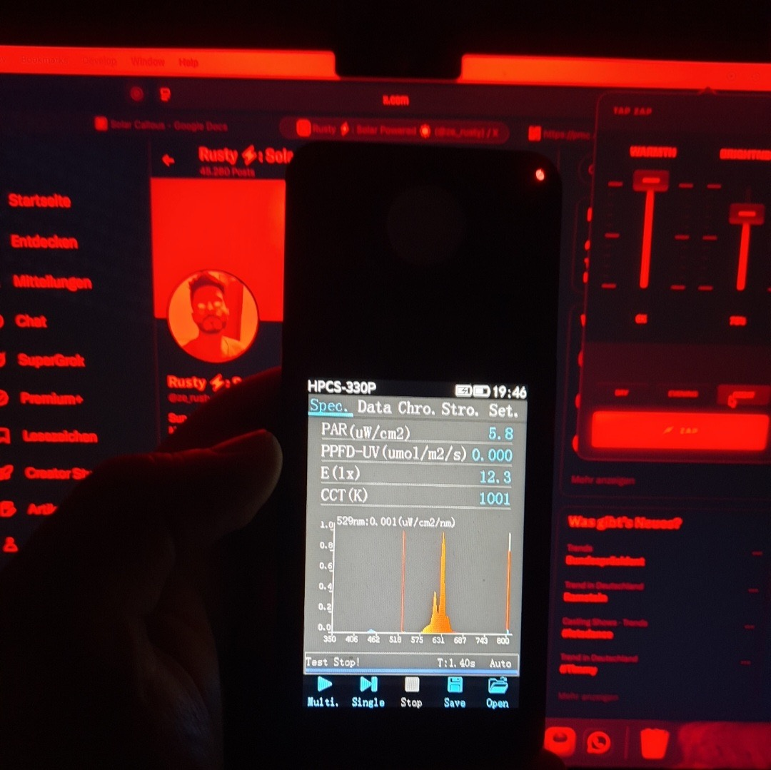 HPCS-330P spectrometer held in front of a screen running Tap Zap at 0K — CCT reading 1001K with the spectrum collapsed into the red tail above 600nm